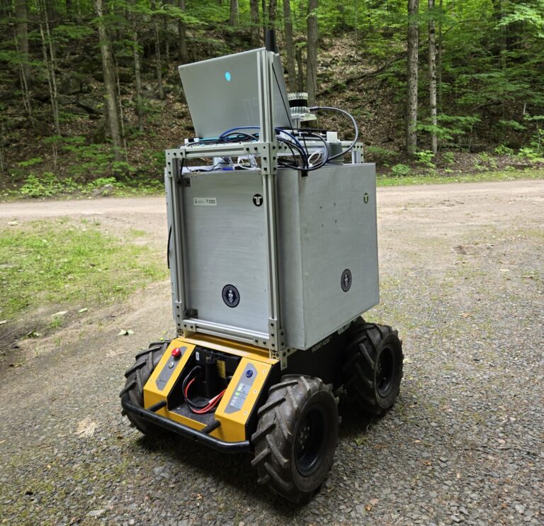 TRAILbot, a Husky A200 rover with a laptop and lidar mounted, on a forest trail